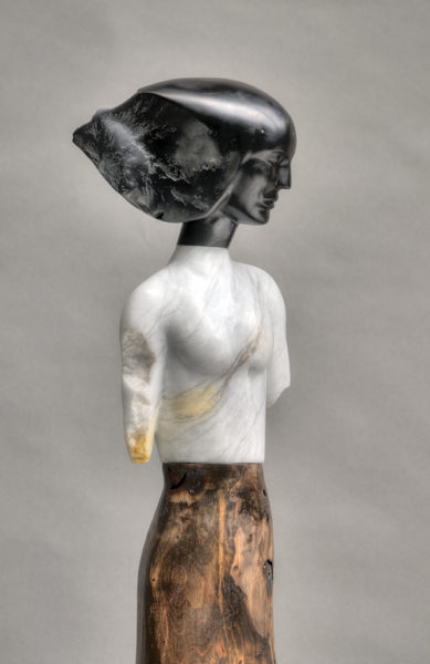A marble statue of a woman with black hair.