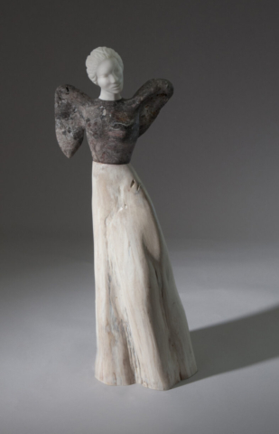 A ceramic sculpture of a woman in white dress.