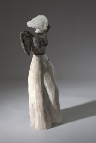 A ceramic statue of an angel with wings.
