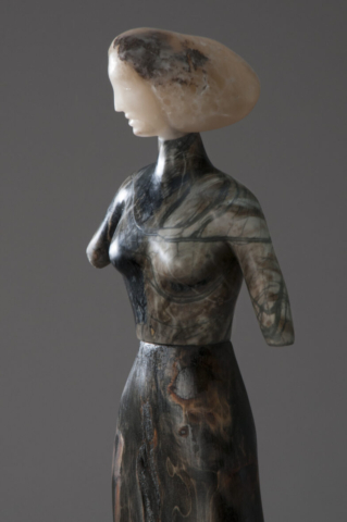 A sculpture of a woman with long hair.